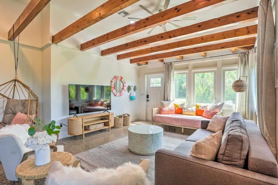 Bright living room with vaulted wooden ceilings and large windows in Fort Pierce, Florida.