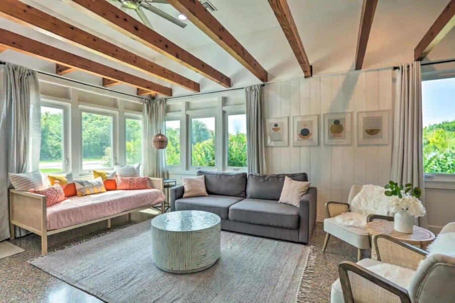 Bright living room with large windows and natural light in Hutchinson Island cottage.