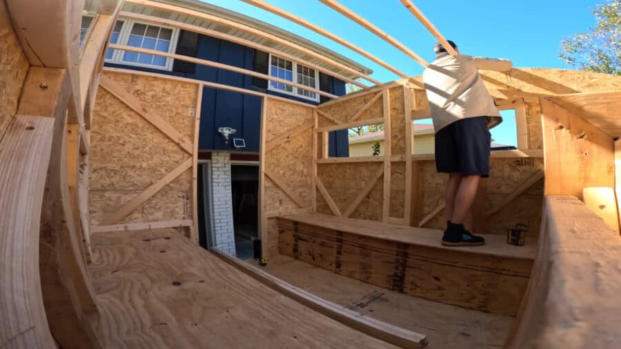 Compact studio apartment built inside a truck for affordable living.