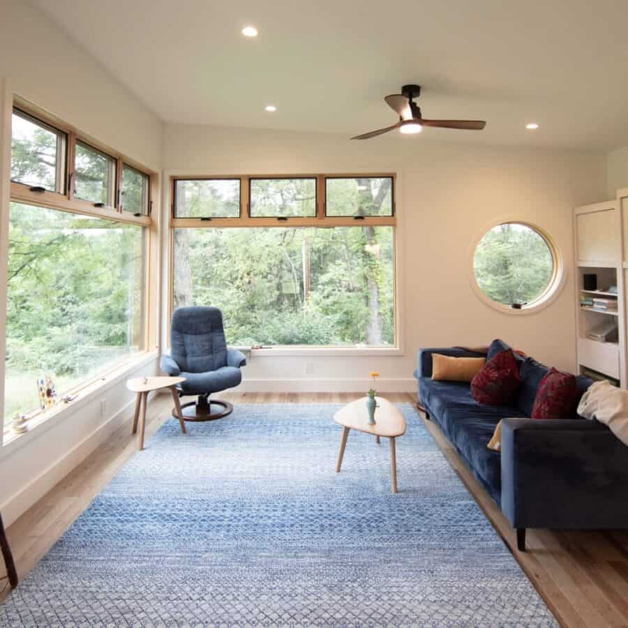 Bright interior of a Nanostead ADU cabin with large windows and modern furnishings in North Carolina.