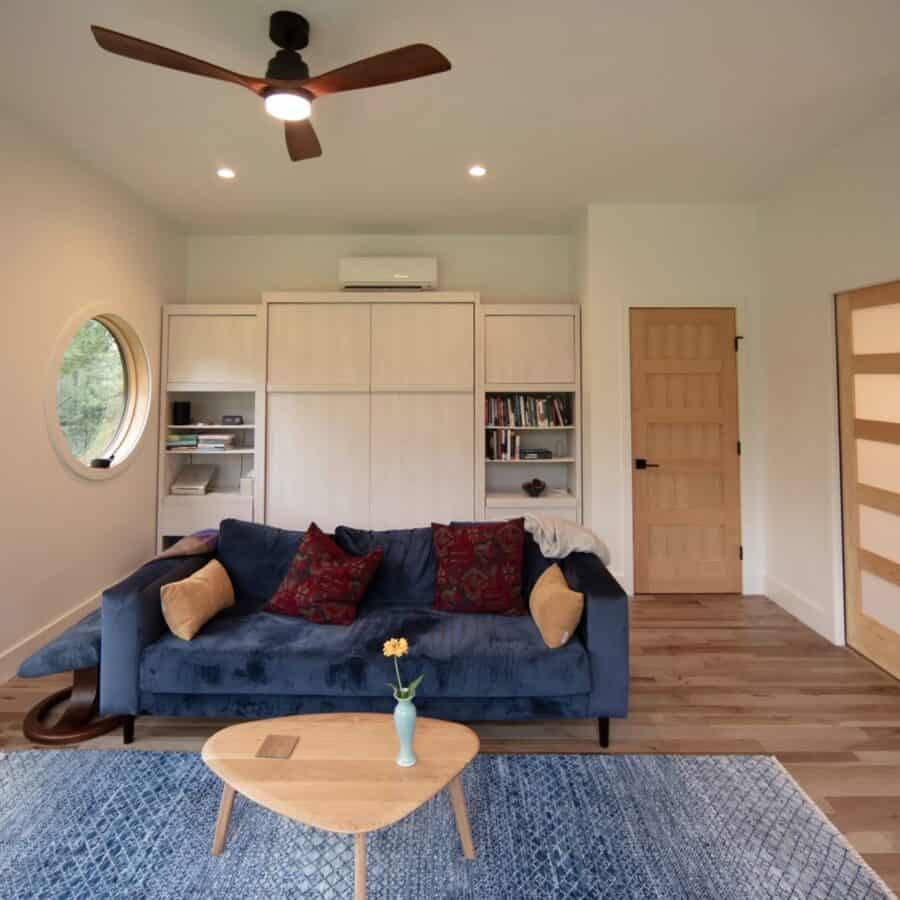 ADU Cabin living room with cozy blue sofa and wooden accents.