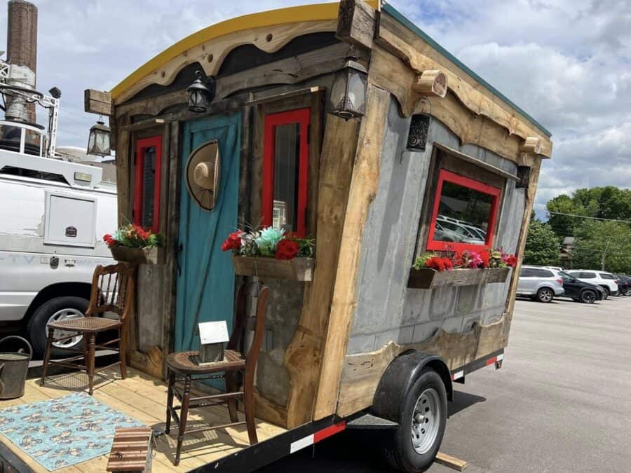 Tiny house on wheels with colorful, rustic design and charming details.