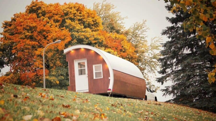Innovation Pod parked on a grassy hillside among autumn trees