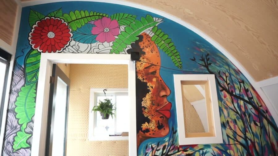 Colorful mural painted inside the Innovation Pod around a window and doorway