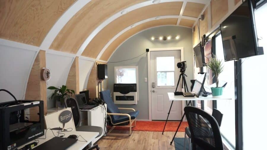 Interior of the Innovation Pod set up as an office with desks and a 3D printer