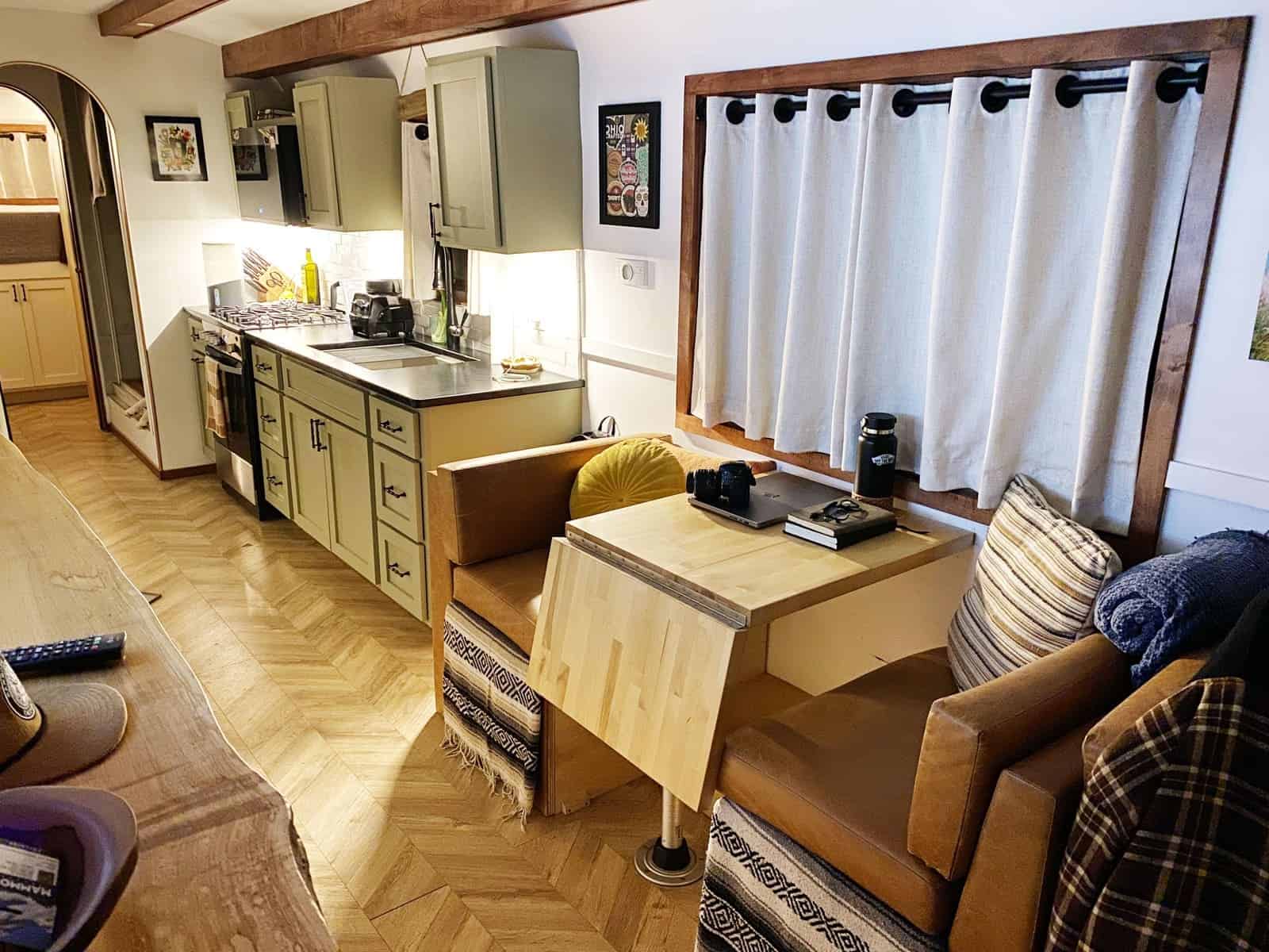 Convertible leather dinette with a butcher-block table beside the kitchen cabinets