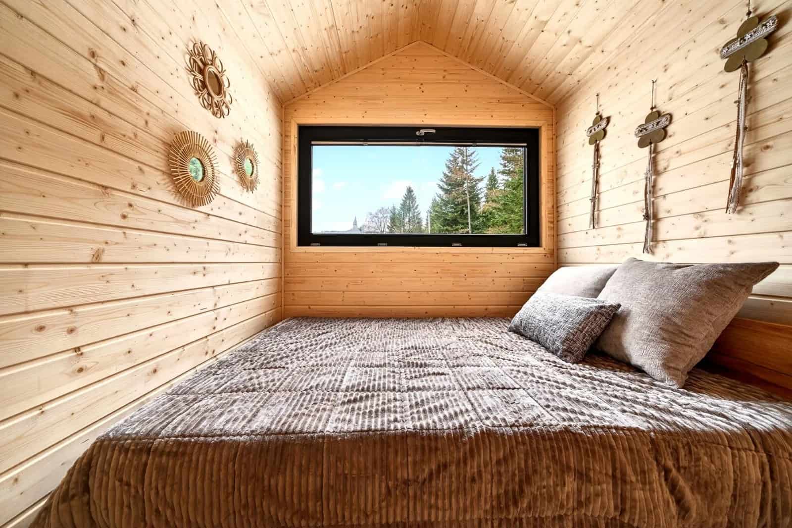 Justine bedroom with a forest-view picture window and decorative wall art