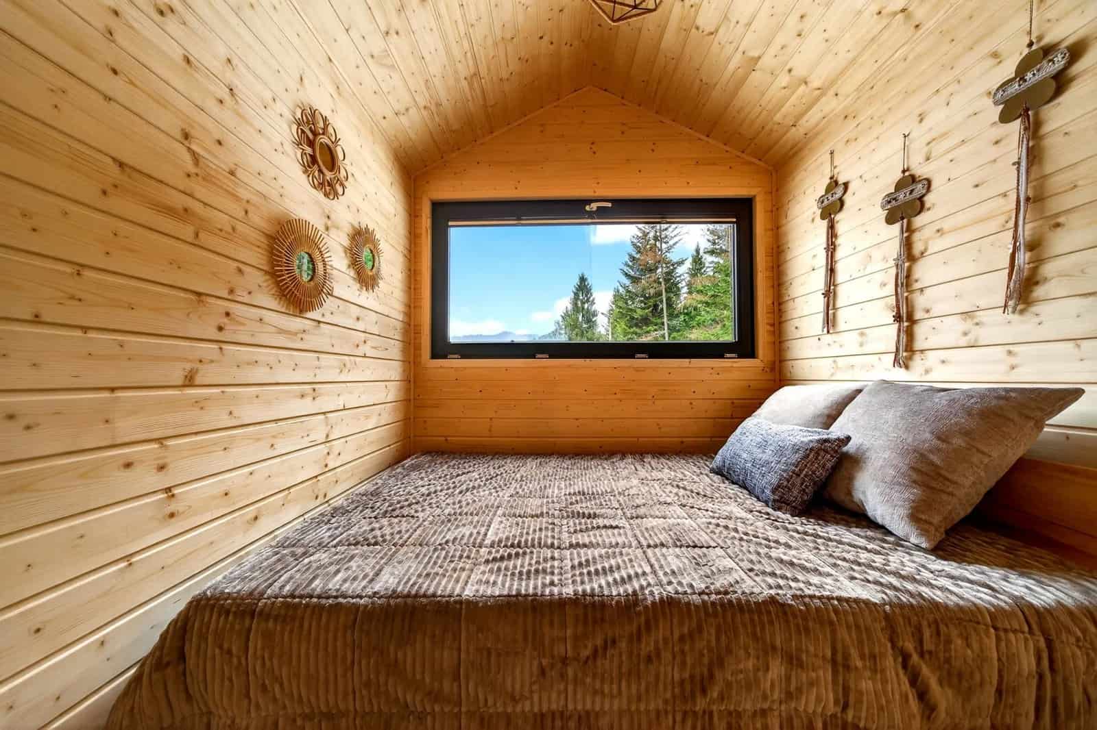 Ground-floor bedroom in the Justine with a double bed under a gable ceiling and a picture window