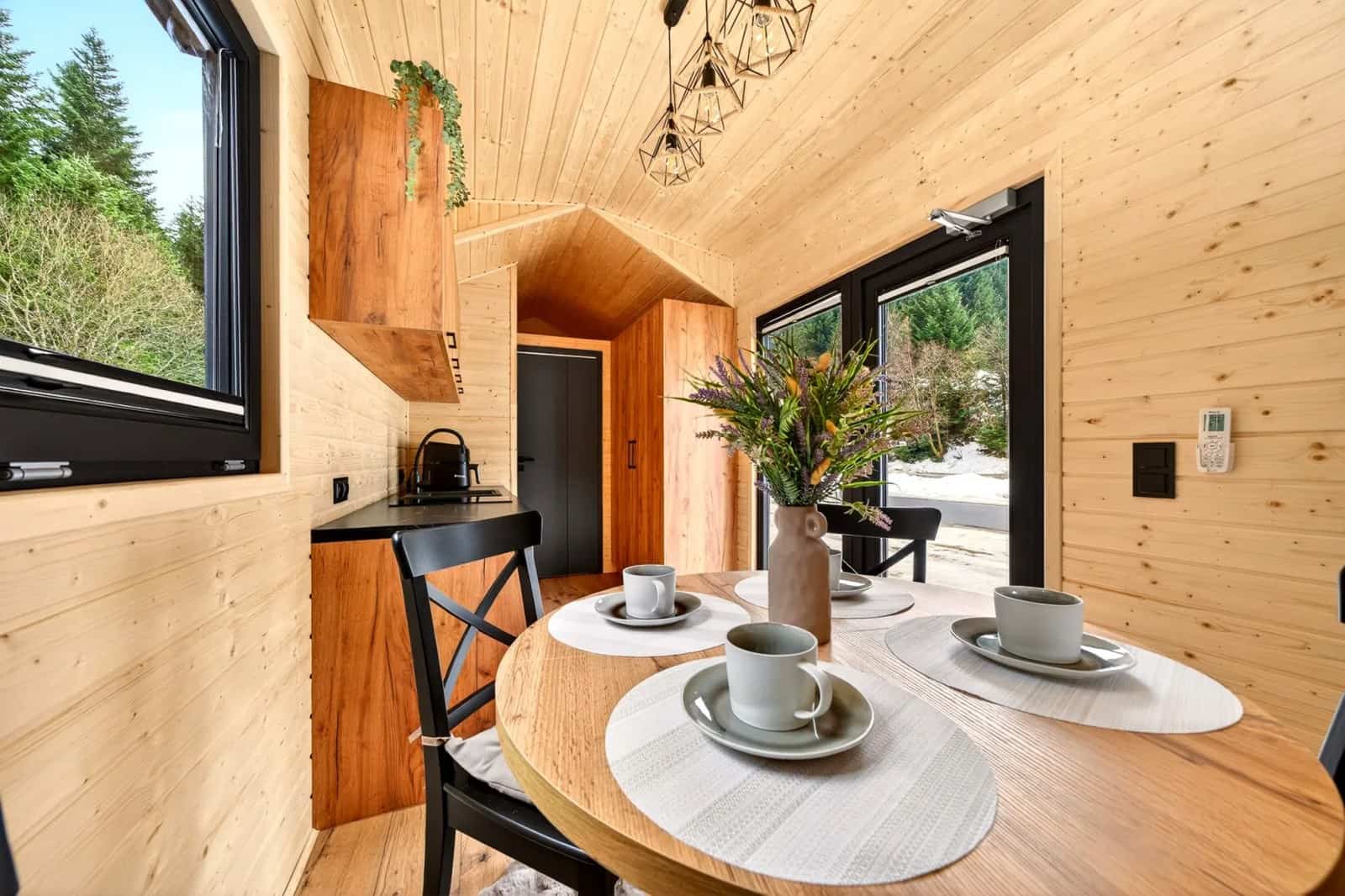 Justine dining and living area looking toward the bedroom door, with floor-to-ceiling glass