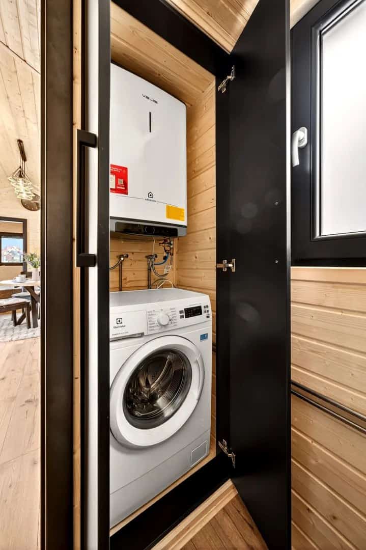 Concealed utility closet in the Justine with a stacked washer and water heater