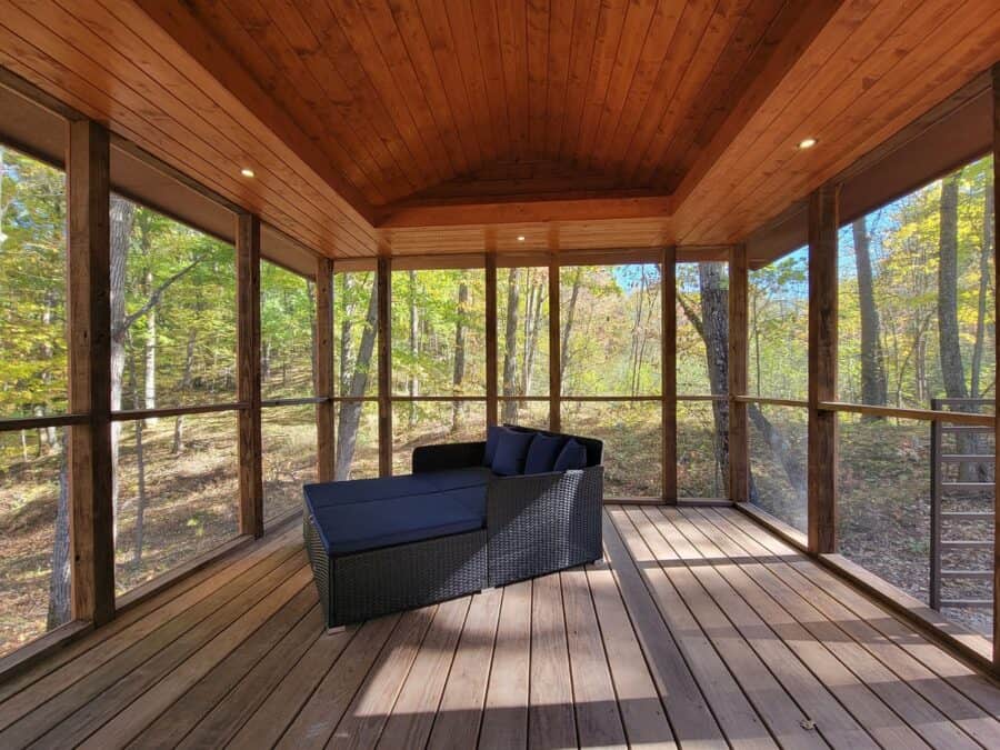 Cozy screened porch of a tiny house with forest views at Canoe Bay.