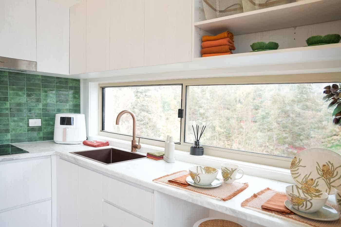 Green stacked tile splashback and copper tapware in the Kookaburra 2.0 kitchen