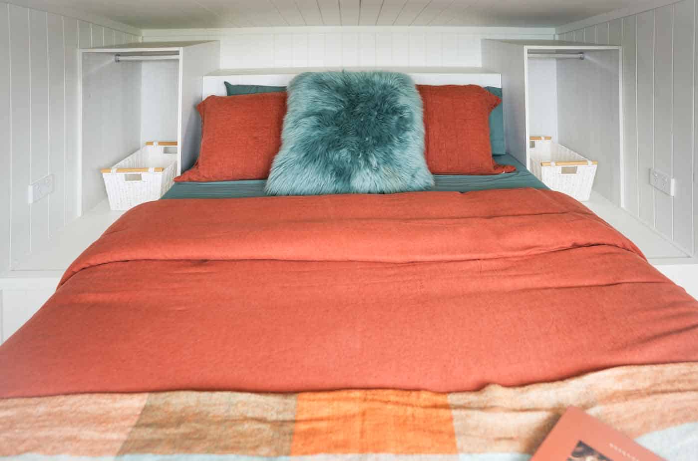 Main loft bedroom in the Kookaburra 2.0 with a queen bed flanked by two built-in wardrobes
