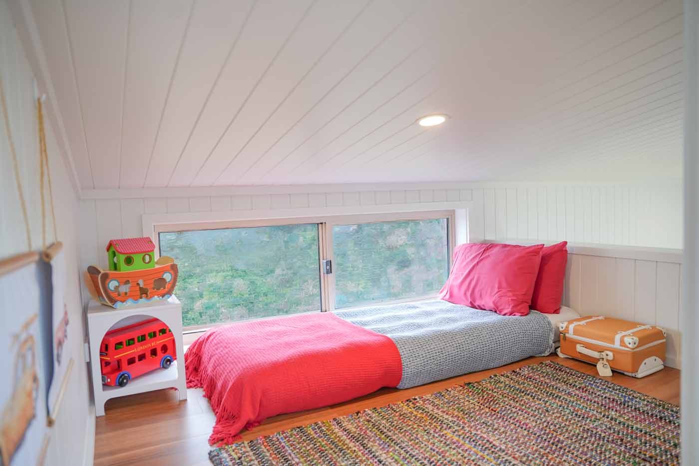 Second loft in the Kookaburra 2.0 set up as a kids bedroom with a single bed under a wide window