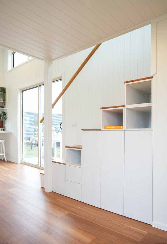 Storage staircase in the Kookaburra 2.0 with drawers, open cubbies, and full-height cabinet doors
