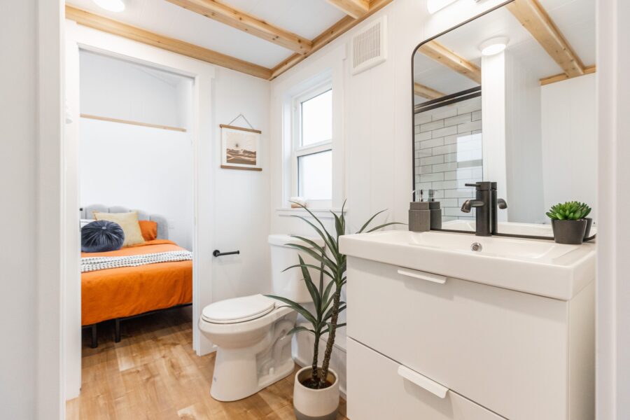 Bright tiny house bathroom with modern sink and toilet.