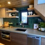 Luxury tiny house kitchen with modern appliances and stylish decor.