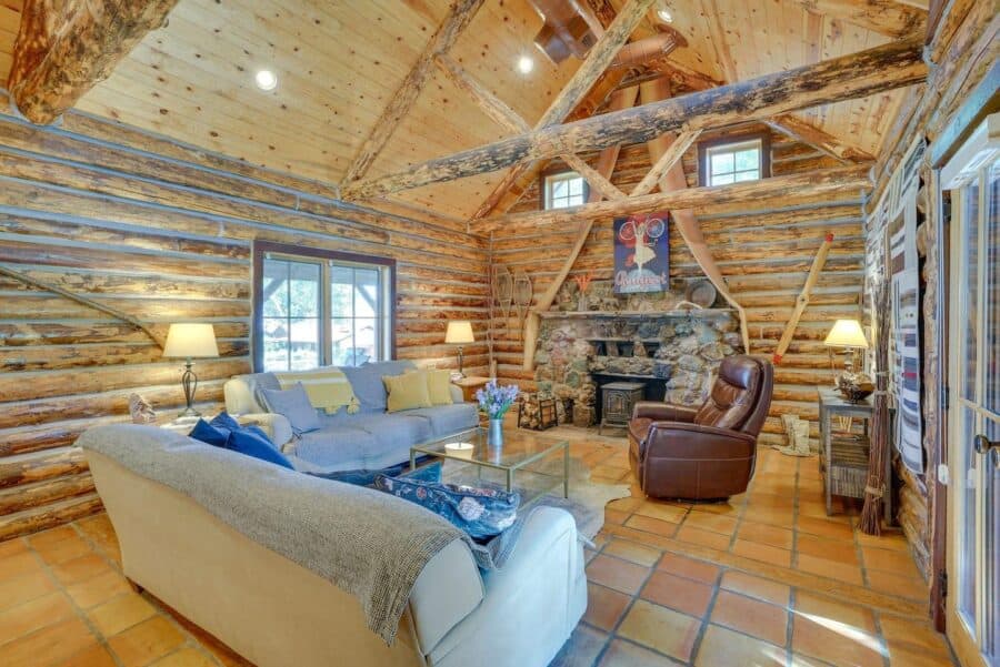Warm log cabin interior with stone accents and rustic decor.