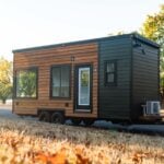 Compact tiny house with modern design and large windows for efficient small space living.