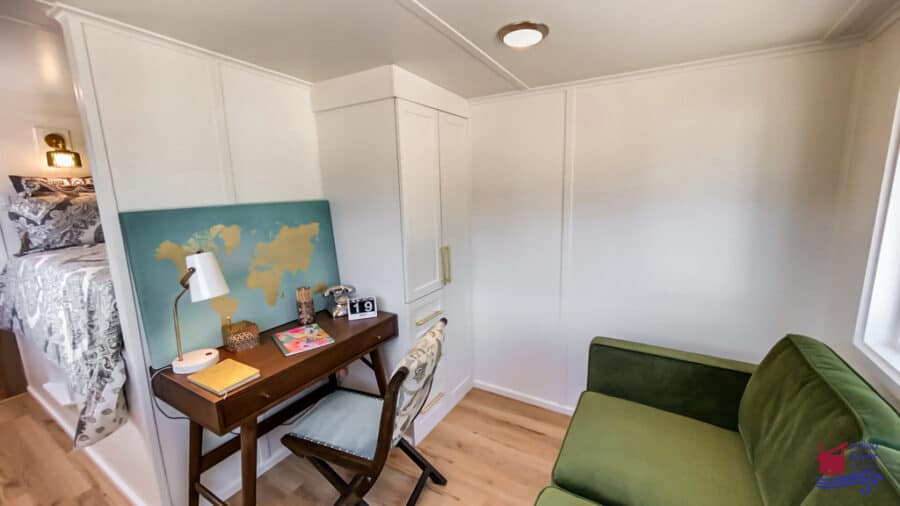 Small tiny house interior with a dedicated home office area and cozy seating.