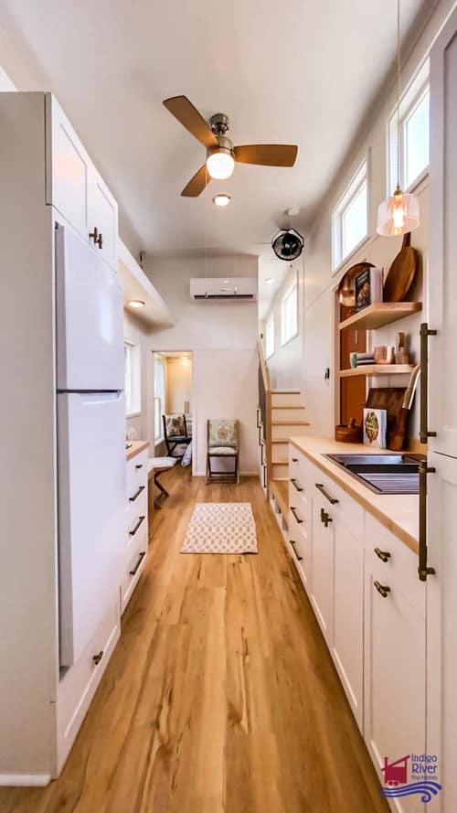 Cozy tiny house interior featuring a functional home office and modern kitchen design.
