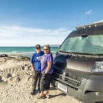 Van life couple enjoying the beach with their self-built ProMaster van.