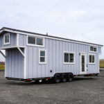 Portable tiny house with modern design on wheels, perfect for small space living.