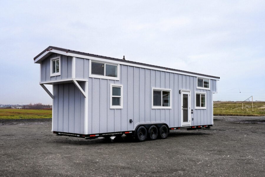 Portable tiny house with modern design on wheels, perfect for small space living.