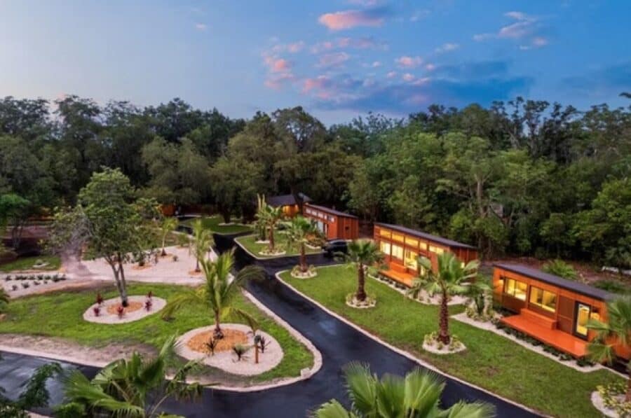 Tiny House Village with modern small homes surrounded by lush greenery.