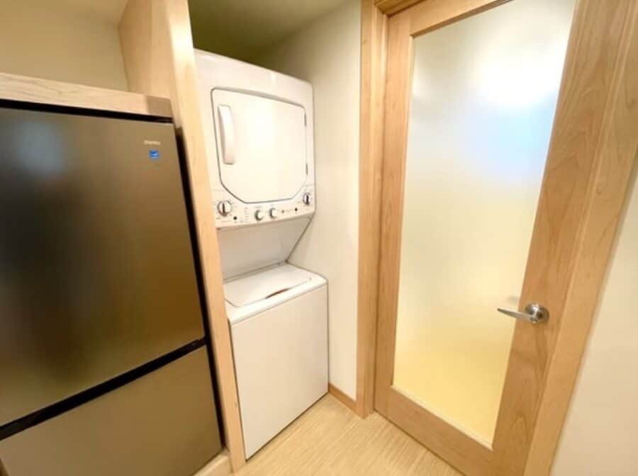 Laundry space with washer and dryer in a compact tiny house.
