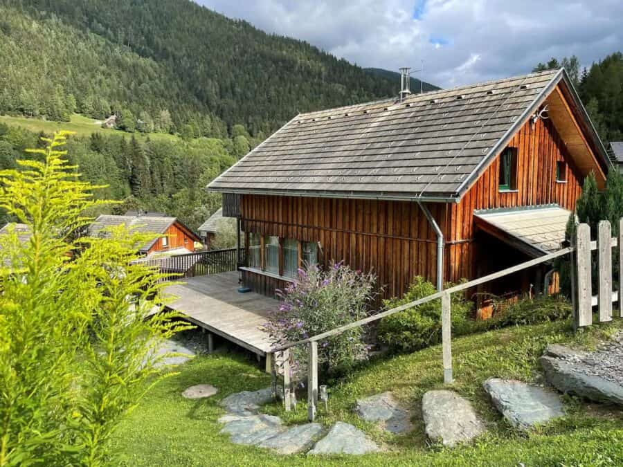 Cozy wooden chalet nestled in lush Austrian mountainside.