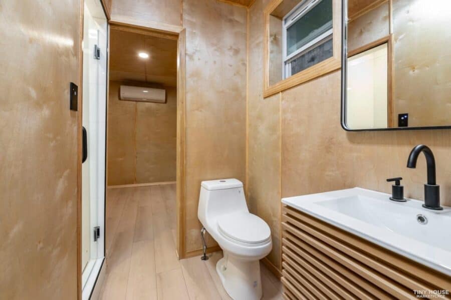 Modern bathroom inside a luxury shipping container home with minimalist design.