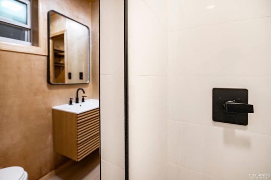 Modern shipping container bathroom with minimalist design and sleek fixtures.
