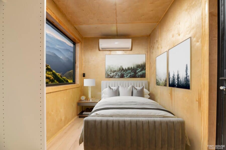 Cozy shipping container home bedroom with scenic mountain views and modern decor.