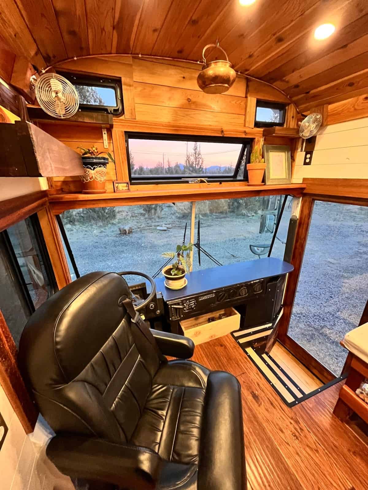 Driver cockpit with leather seat copper pendant light and wood paneling details