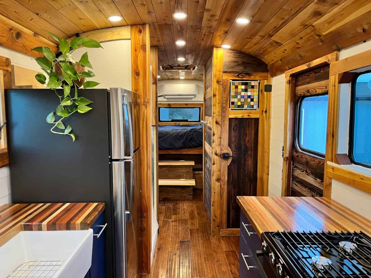 View toward bedroom showing artisan stained glass bathroom door mini-split AC and refrigerator