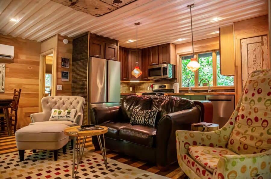 Charming tiny house interior with warm wood accents and comfortable seating in a magical forest sett.
