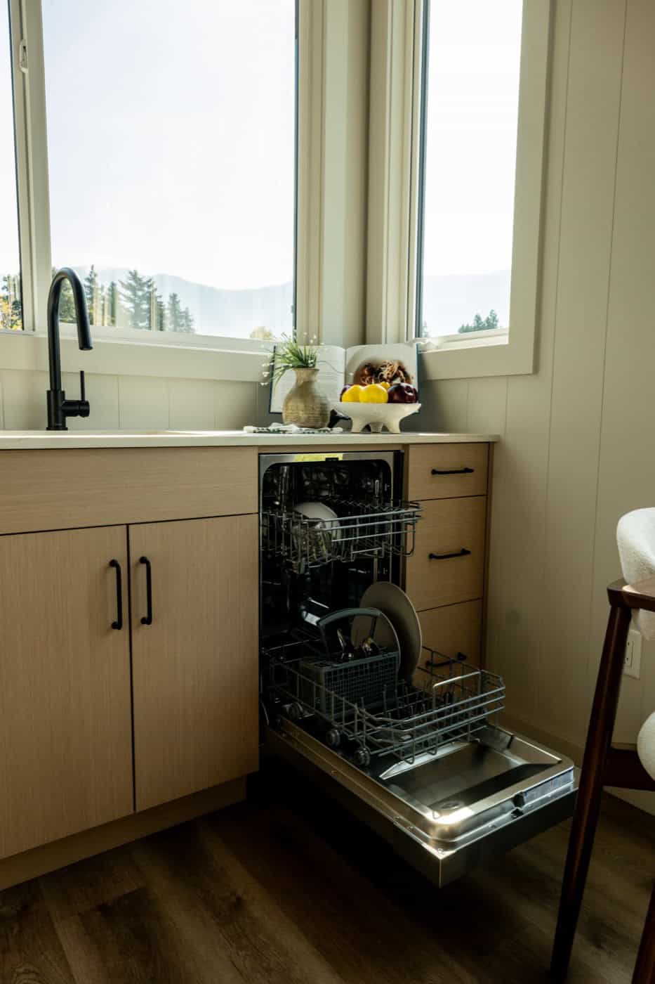 Open 18-inch stainless dishwasher installed beside the kitchen sink in the Mint Ventura