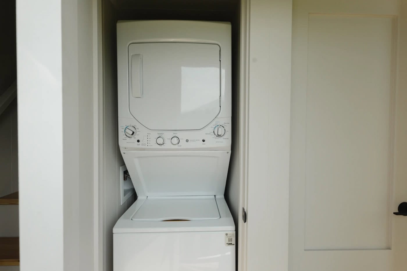 Stacked 220V washer and dryer laundry center in a closet in the Mint Ventura