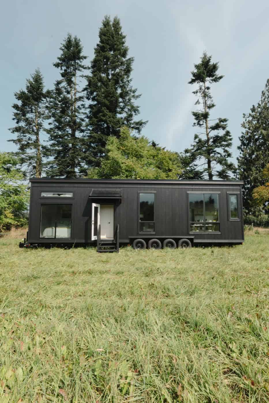 Front elevation of the Mint Ventura park model with the entry door open and bedroom slider visible