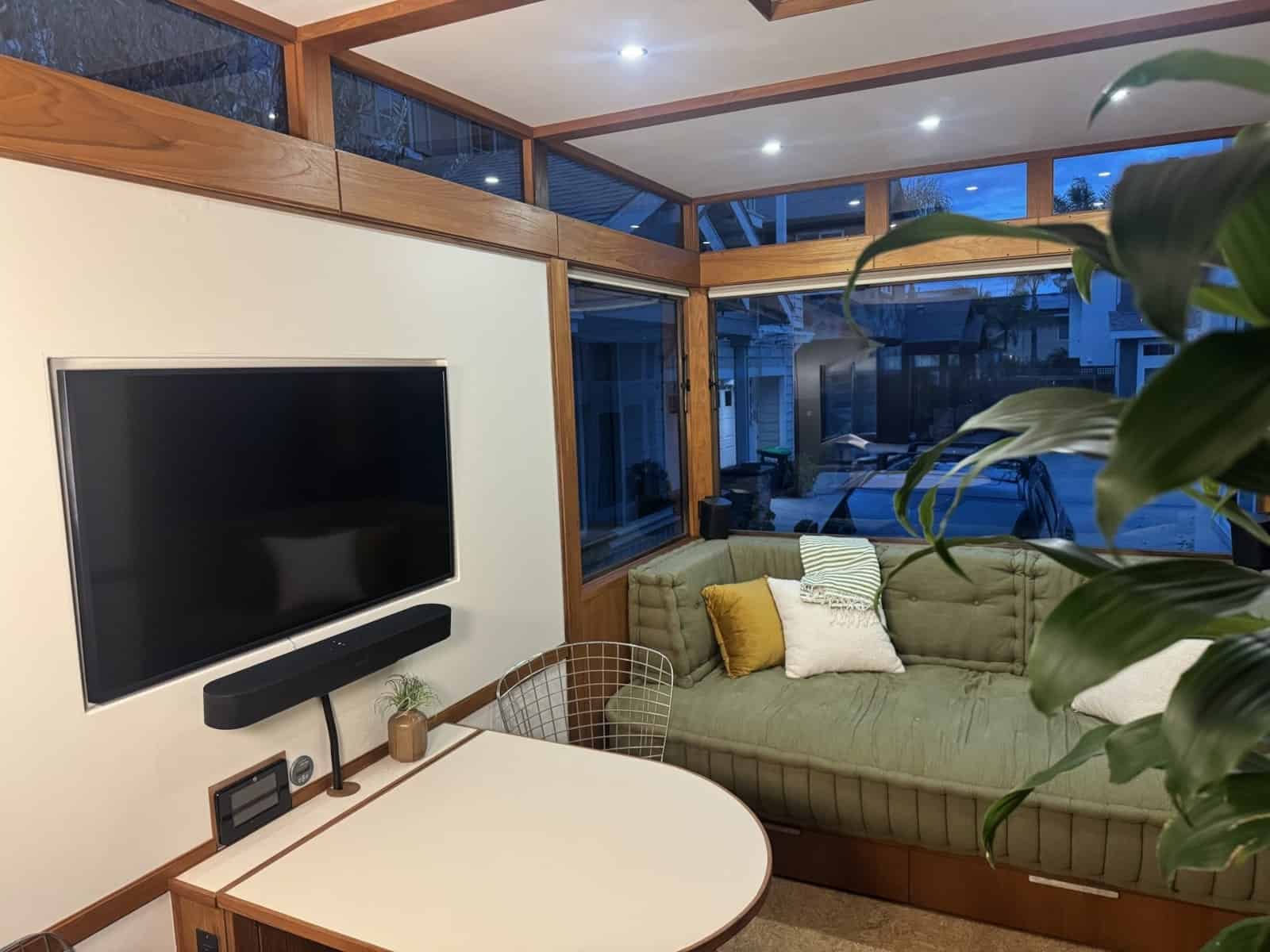Samsung Frame TV and dining table opposite the daybed in the MoD tiny house