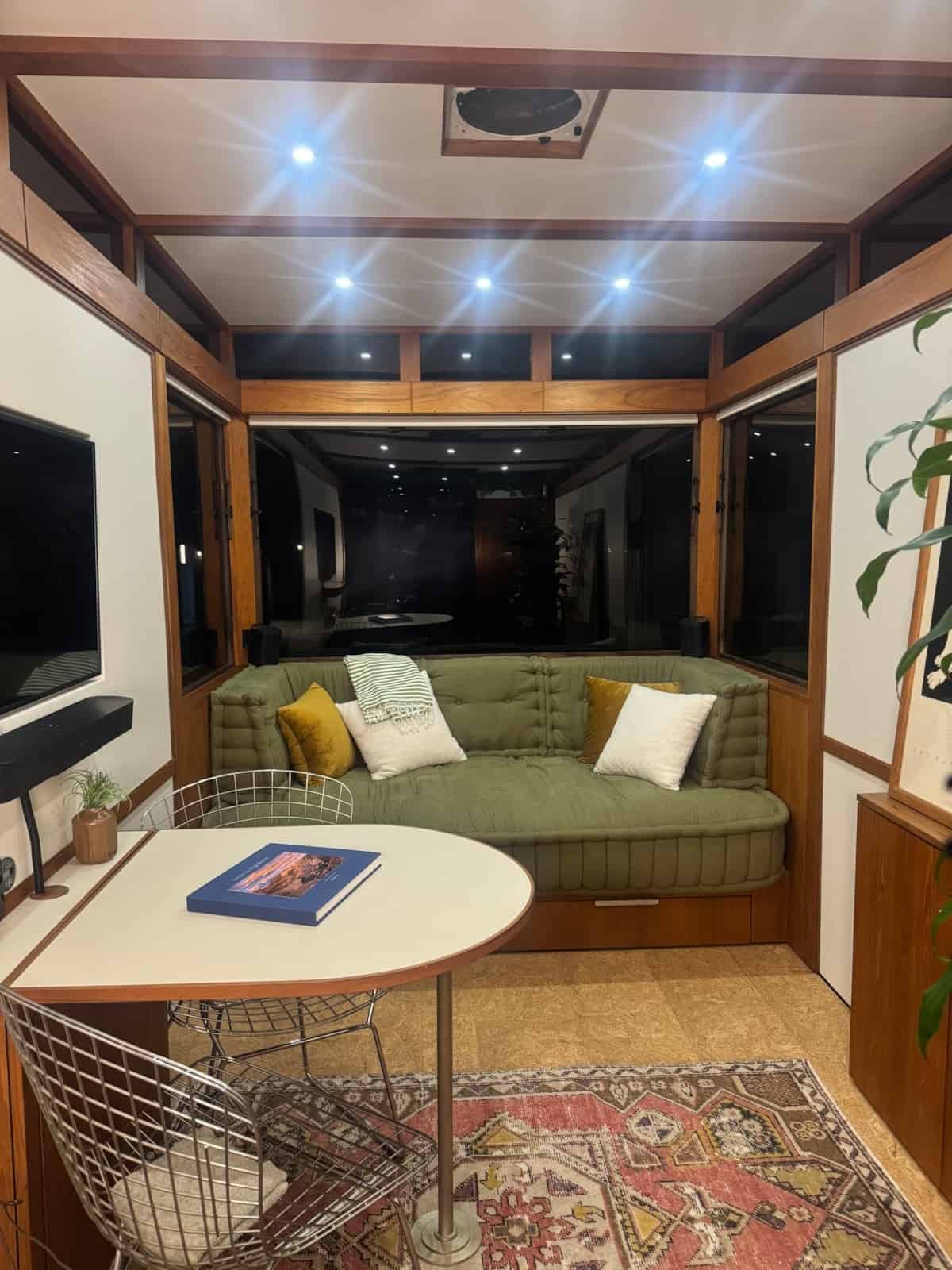 Evening view of the MoD tiny house interior with recessed lighting and teak ceiling beams