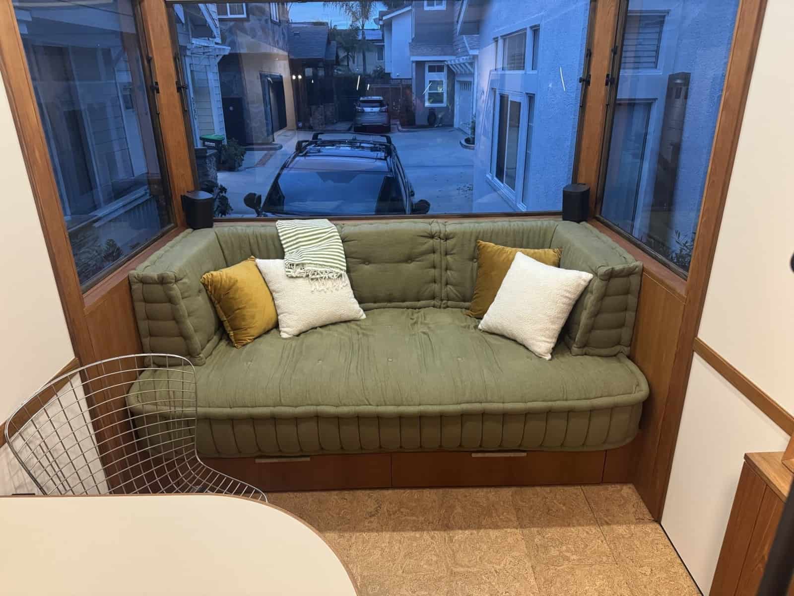 Green Mah Jong style daybed built into the corner of the MoD tiny house