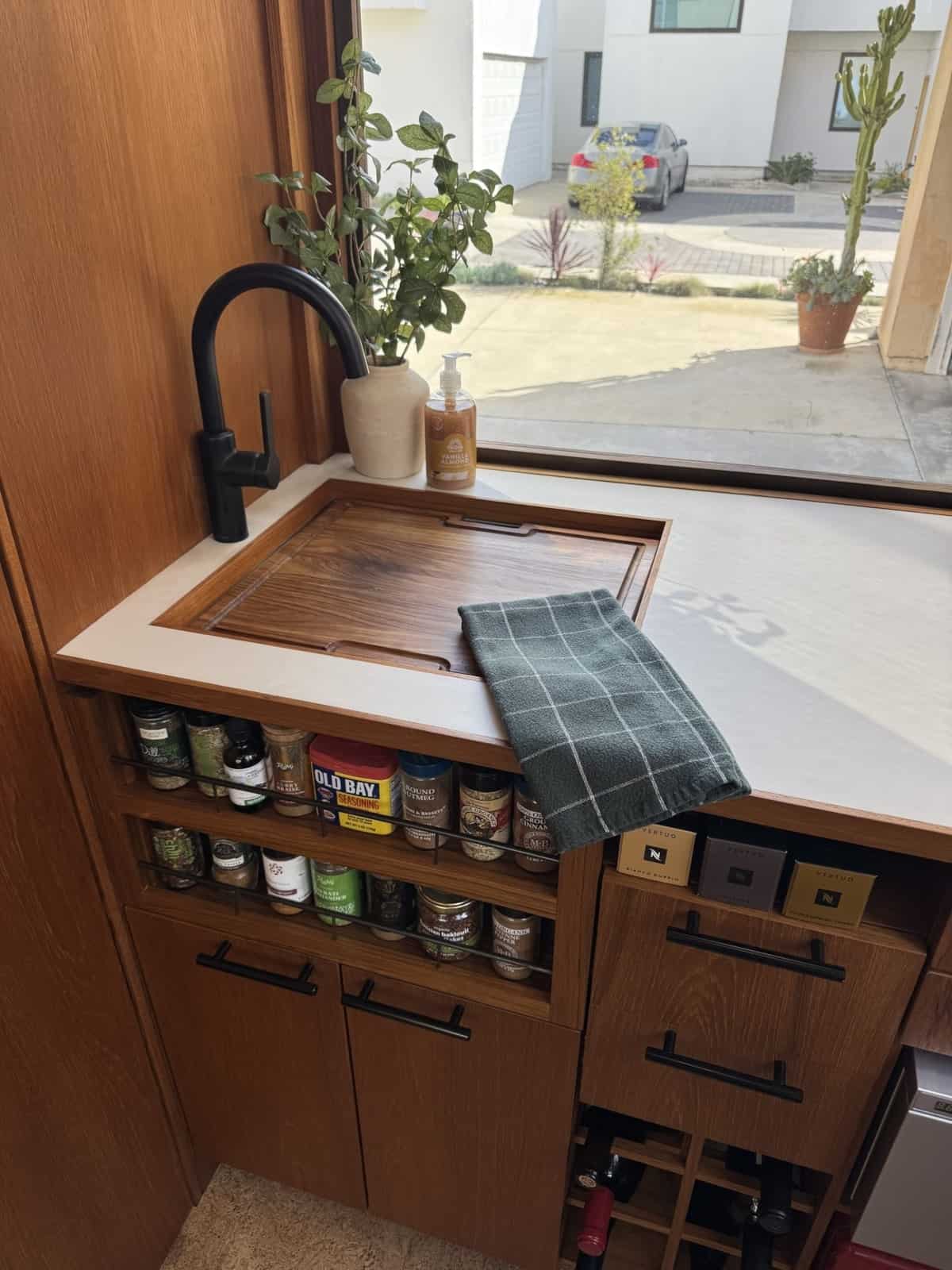Kraus sink in the MoD tiny house fitted with a solid teak cutting board cover