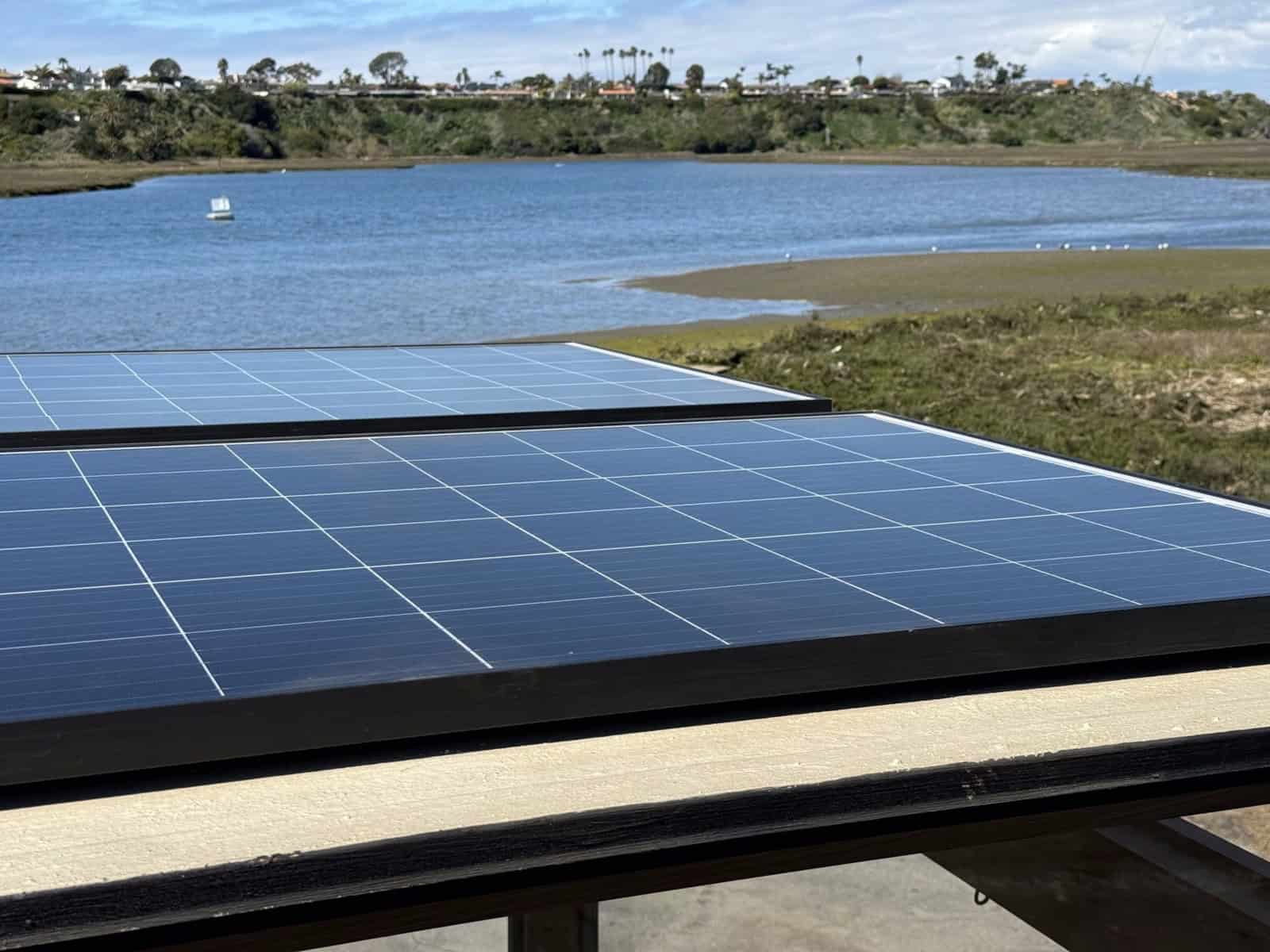 Monocrystalline solar panels on the MoD tiny house roof overlooking a coastal estuary