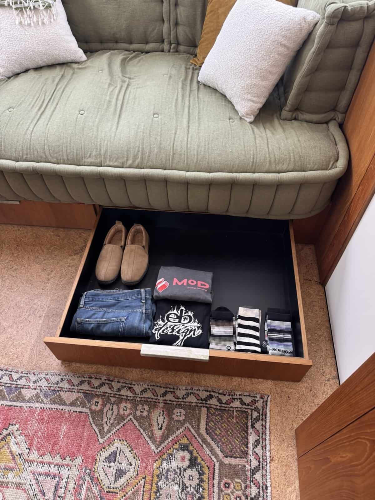 Full-width storage drawer pulled out from beneath the daybed platform