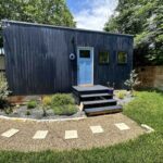 Tiny House in East Austin with modern black exterior and small front porch.