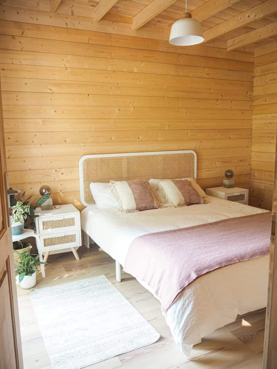 Warm wooden bedroom with minimalist decor near Portuguese hiking trails.