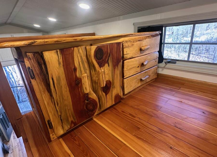 Storage cabinet made from natural wood with rustic knots and a smooth finish.