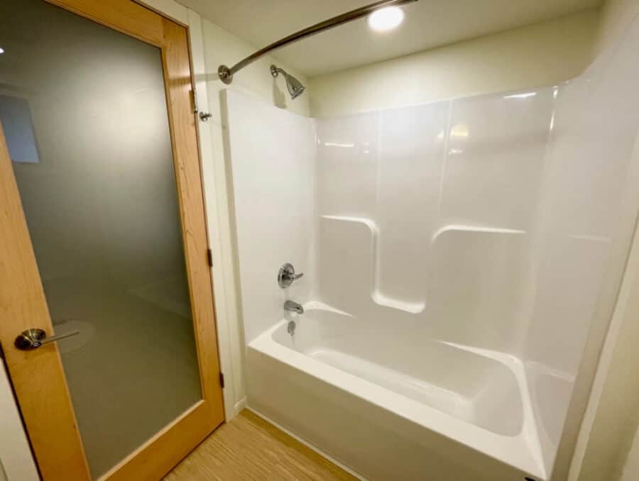 Full bathroom with one-piece tub and shower surround